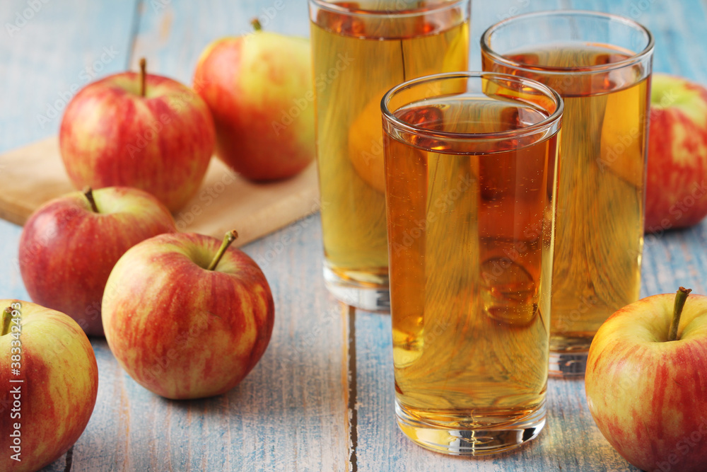 Glasses with apple juice and ripe apples Glasses with apple juice and ripe apples
