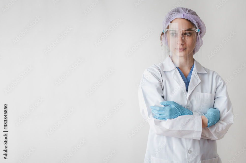 Portrait of female medical doctor wearing face shield for protect coronavirus with arms cross on white background Portrait of female medical doctor wearing face shield for protect coronavirus with arms cross on white background