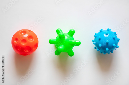 Colorful plastic balls as viruses on the white paper background, medical concept