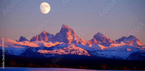 Sunset Light Alpen Glow on Tetons Teton Mountains wtih Moon Rising