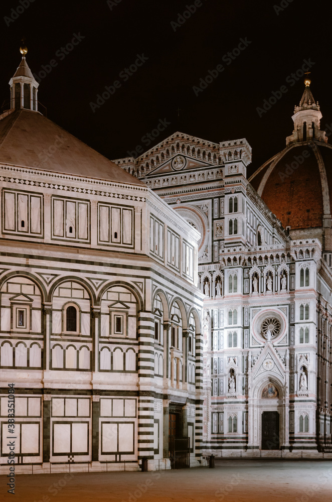 Facade of the famous basilica of Santa Maria del Fiore (Saint Mary of the flower), cathedral of Florence, Italy, with the medieval baptistery and the dome of brunelleschi at night