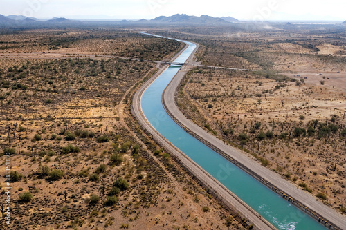Leinwand Poster Irrigation canal winding thru the Arizona desert