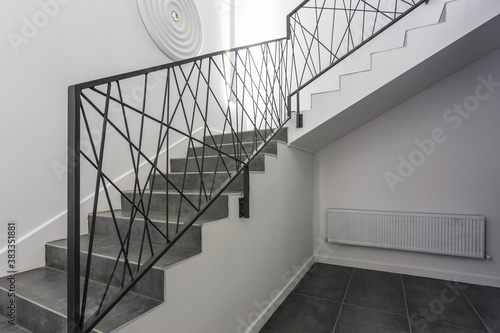 Fotografija white stairs  emergency and evacuation exit spiral stair in up ladder in a new o