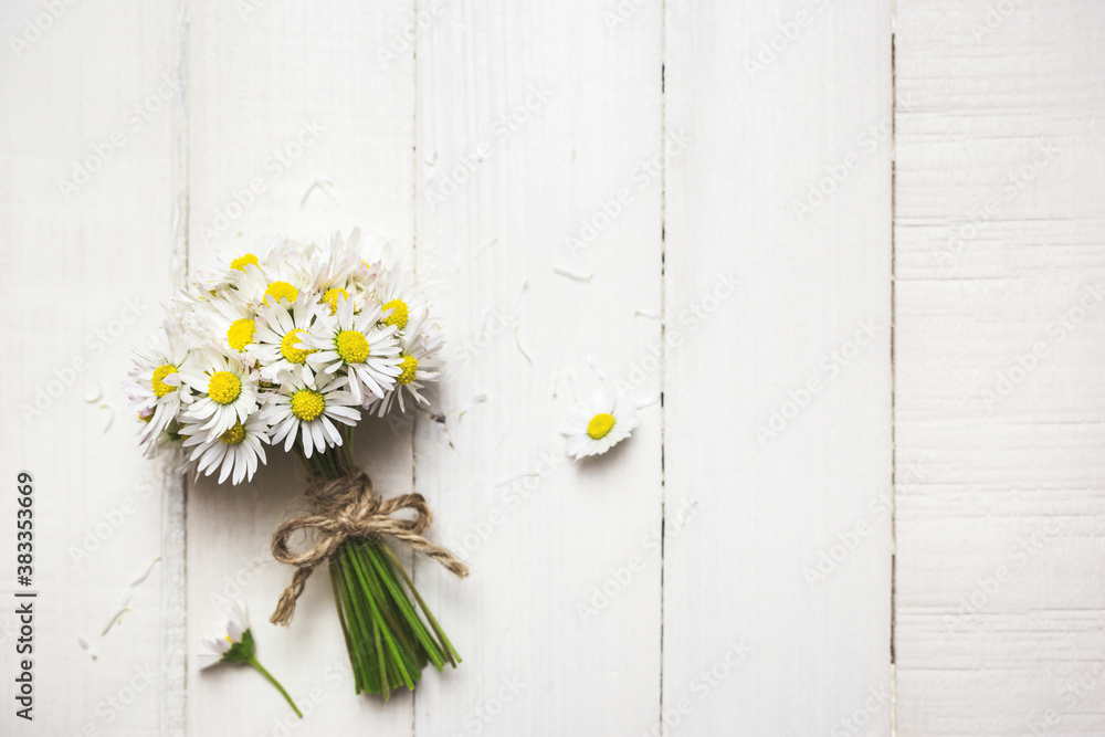 Fototapeta premium Beautiful daisy flowers on a white table