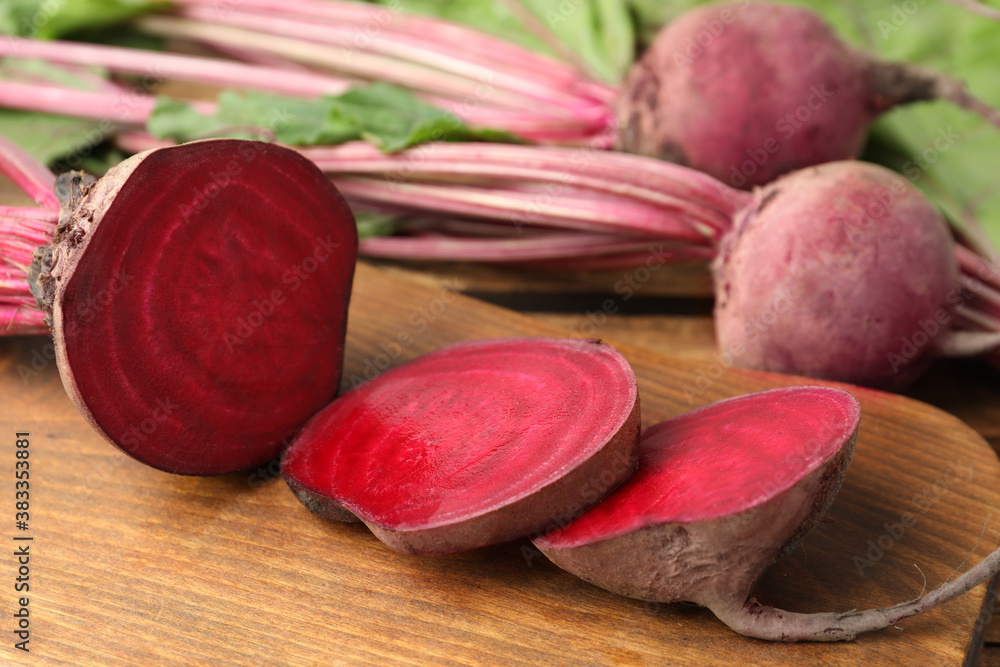 Cut ripe beet on wooden board, closeup Cut ripe beet on wooden board, closeup
