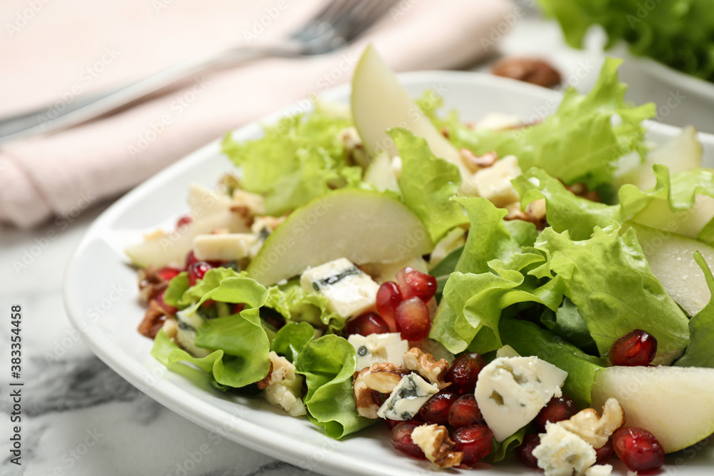 Tasty salad with pear slices on white table, closeup Tasty salad with pear slices on white table, closeup
