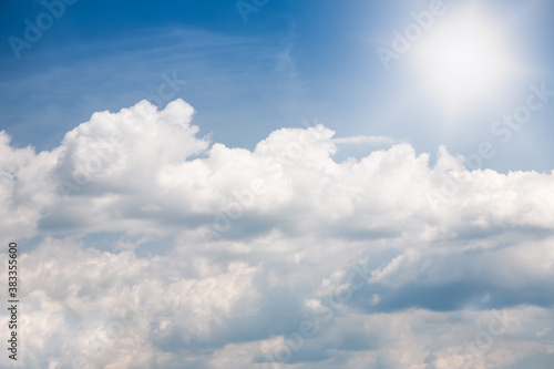 White cumulus clouds formation in blue sky in summer sunny day