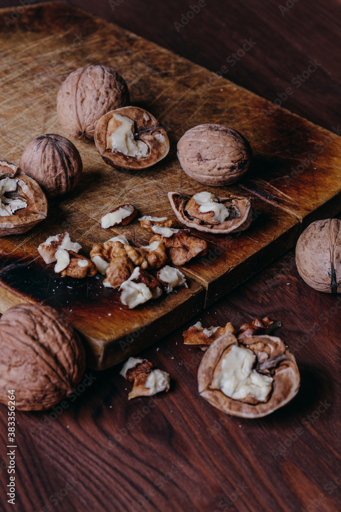 Walnut kernels and whole walnuts on rustic old wooden table. Walnut kernels and whole walnuts on rustic old wooden table.