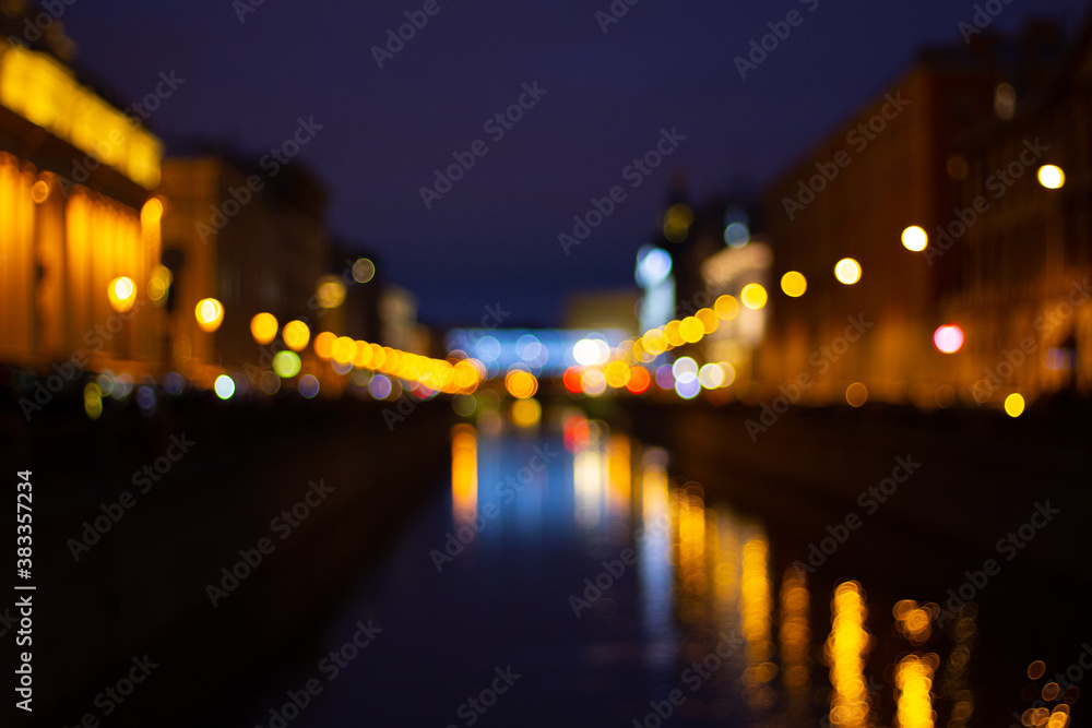 Blurred abstract bokeh background of Saint Petersburg golden lights on Griboyedov Canal at night