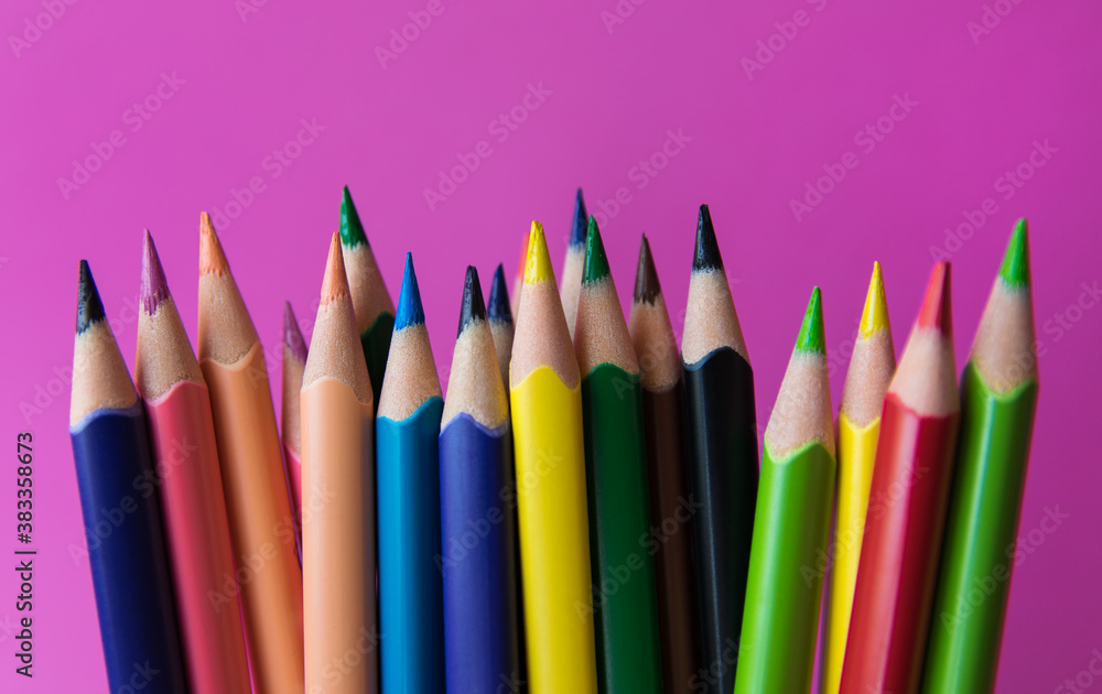 A lot of colour pencils on the pink background. A lot of colour pencils on the pink background.