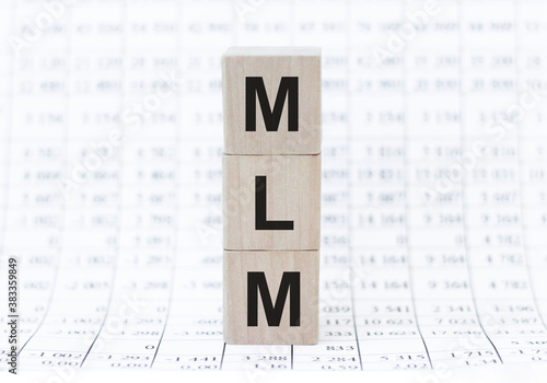 MLM 2020 word written on wood block. Faqs text on table, concept