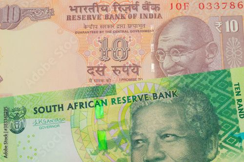 Wallpaper Mural A macro image of a orange ten rupee bill from India paired up with a shiny, green 10 rand bill from South Africa.  Shot close up in macro. Torontodigital.ca
