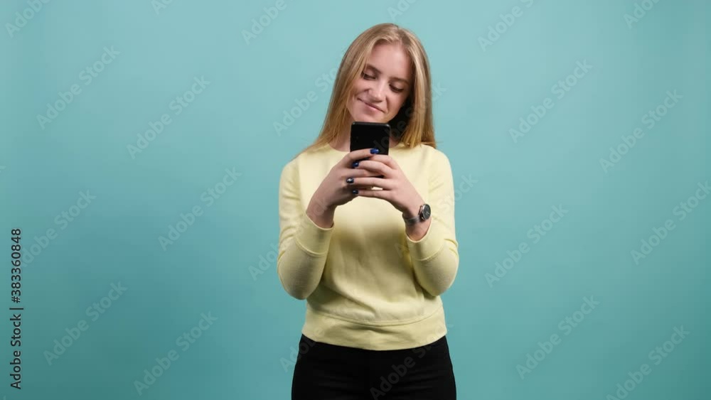 Young happy woman using smartphone. Excited surprised girl texting on her mobile phone. Young happy woman using smartphone. Excited surprised girl texting on her mobile phone.