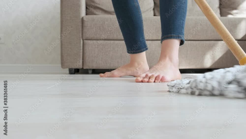 A woman dances and washes the floor. Great mood during cleaning. Happiness and joy. MOP close-up. Slow motion A woman dances and washes the floor. Great mood during cleaning. Happiness and joy. MOP close-up. Slow motion
