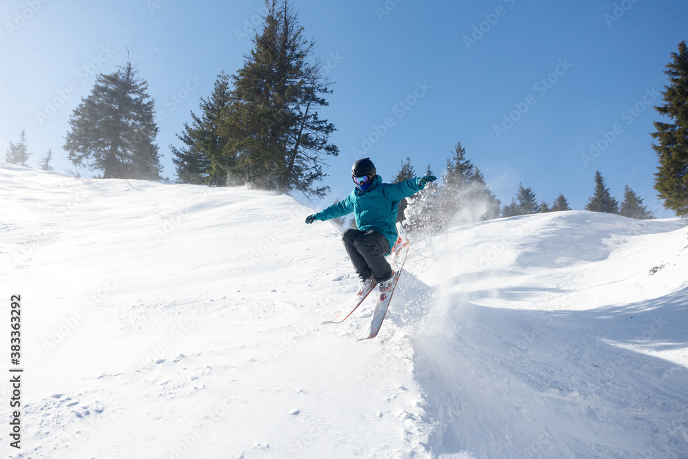 winter, leisure, sport and people concept - Skier in mountains, prepared piste and sunny day. Happy Skier. Extreme sport.