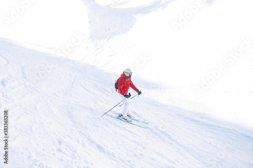 winter, leisure, sport and people concept - Skier in mountains, prepared piste and sunny day. Happy Skier. Extreme sport.