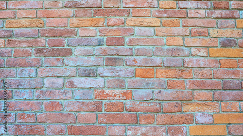 old brick wall of bricks of different colours as the background