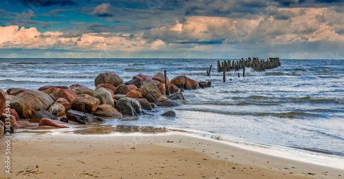 Abandoned old broken pier at Baltic Sea, autumn storm with drops of rain, con...