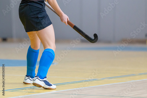 Undefined female indoor hockey player with stick