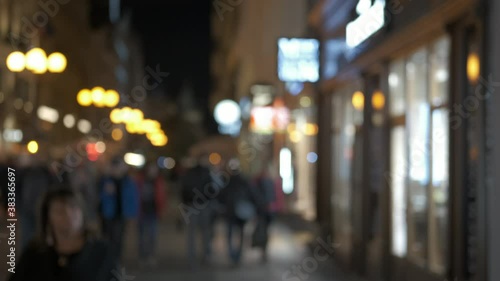 Wallpaper Mural Citizens in the night town street. European pedestrian street with glass windows in the evening in blur. Torontodigital.ca
