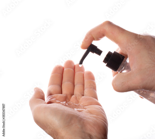 a man squeezes antiseptic gel from a transparent plastic bottle onto his hands on a white background. concept of counteracting the virus, clean hands.