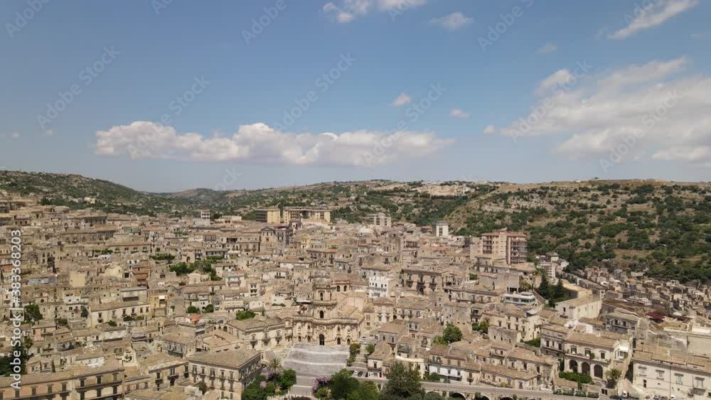 The baroque Saint George cathedral of Modica from the height, view from drone, in the province of Ragusa in Sicily, Italy The baroque Saint George cathedral of Modica from the height, view from drone, in the province of Ragusa in Sicily, Italy