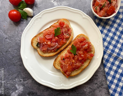 Vegetarian, italian tomato bruschetta with chopped tomatoes, onions, garlic, olive oil and spices.