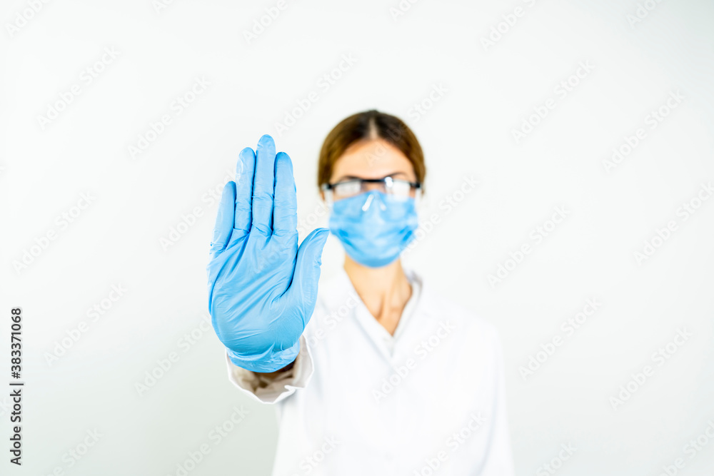 Young doctor woman, medical professional annoyed with bad attitude making stop sign with hand, saying no, expressing security, defense or restriction, maybe pushing Young doctor woman, medical professional annoyed with bad attitude making stop sign with hand, saying no, expressing security, defense or restriction, maybe pushing