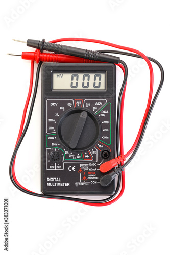 Digital electrical tester multimeter in black case isolated on white background. Digital multimeters have a numeric display, can measure voltage, current and resistance. Close-up.