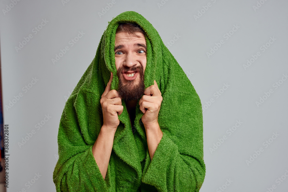 Bearded man in green robe cropped view gray background close-up Bearded man in green robe cropped view gray background close-up