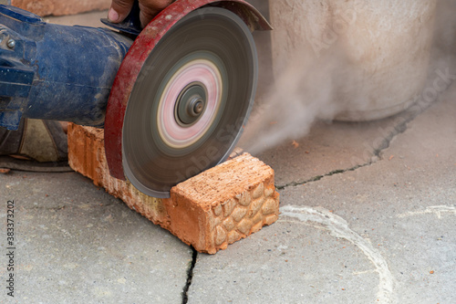 The process of sawing bricks with a grinder with a diamond disc