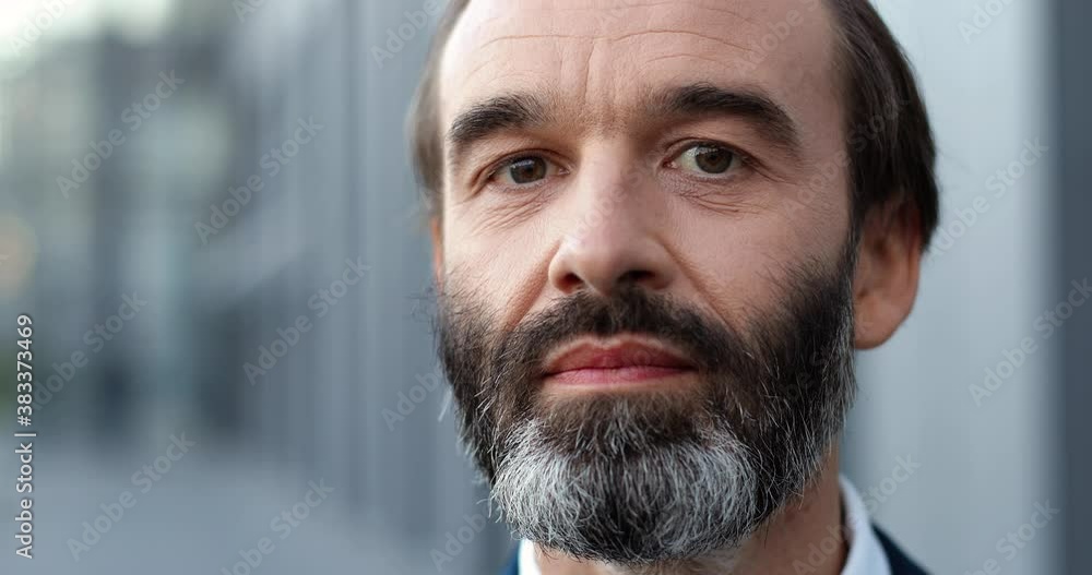 Portrait shot of Caucasian middle-aged man with beard standing outdoors and looking at camera. Pandemic coronavirus concept. Close up of male businessman. Portrait shot of Caucasian middle-aged man with beard standing outdoors and looking at camera. Pandemic coronavirus concept. Close up of male businessman.
