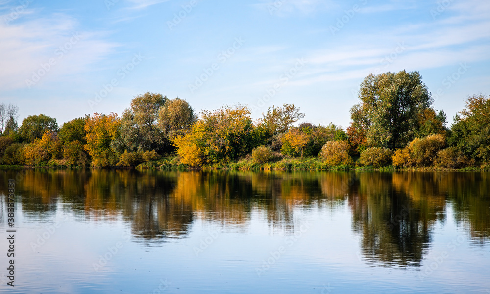The forest river is reflected in the water. Beautiful autumn landscape The forest river is reflected in the water. Beautiful autumn landscape