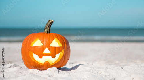 Halloween party on the beach. Pumpkin Jack-o'-lantern. Jack o lantern for Happy Halloween. Autumn season. On background ocean. Autumn in Florida. Fall season. Copy space. © artiom.photo