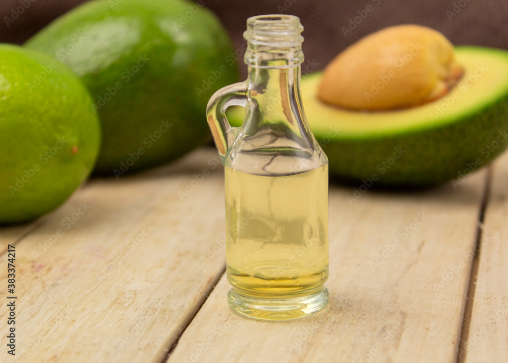 Healing avocado oil on a wooden background Healing avocado oil on a wooden background