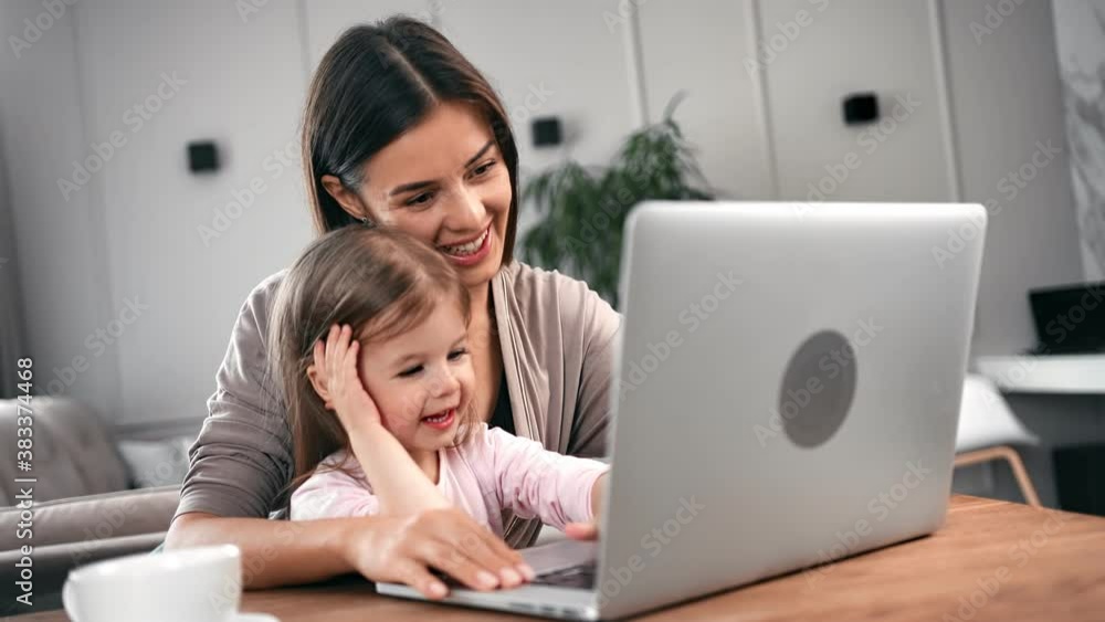 Woman and cute daughter studying computer or surfing internet. Medium close up shot on 4k RED camera