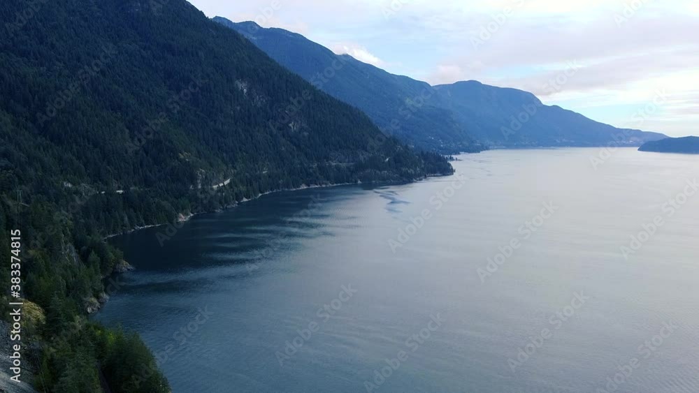 Aerial view of the river with the adjacent mountains covered with green forest Aerial view of the river with the adjacent mountains covered with green forest