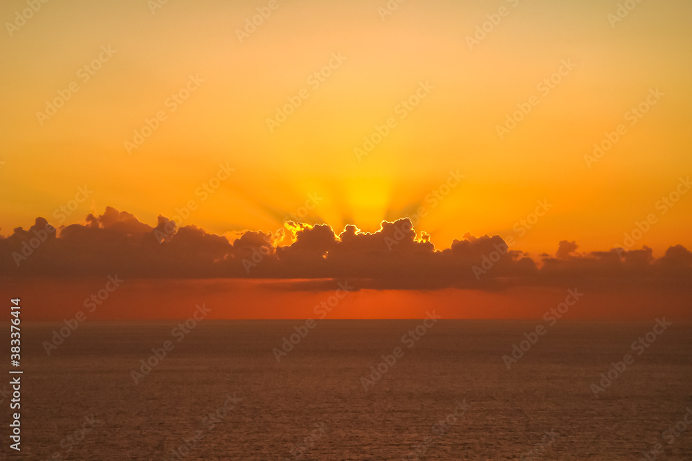 Beautiful sunset above the sea. Gorgeous panorama scenic of sunrise with cloud on the orange sky.