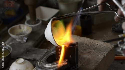 The jeweler melts gold in a liquid state in a crucible. Macro video. Craft jewelery making with professional tools. The process of making handmade jewelry, jewelry making. Metal melting