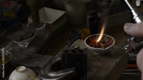 The jeweler melts gold in a liquid state in a crucible. Macro video. Craft jewelery making with professional tools. The process of making handmade jewelry, jewelry making. Metal melting