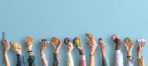 People are holding different desserts in their hands. The concept of food and sweets. photo
