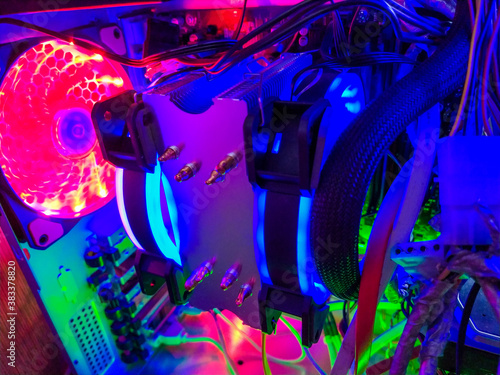 Modern computer air cooling with multi-colored led backlight-fans, cooling radiators, cables, boards, close-up, macro.