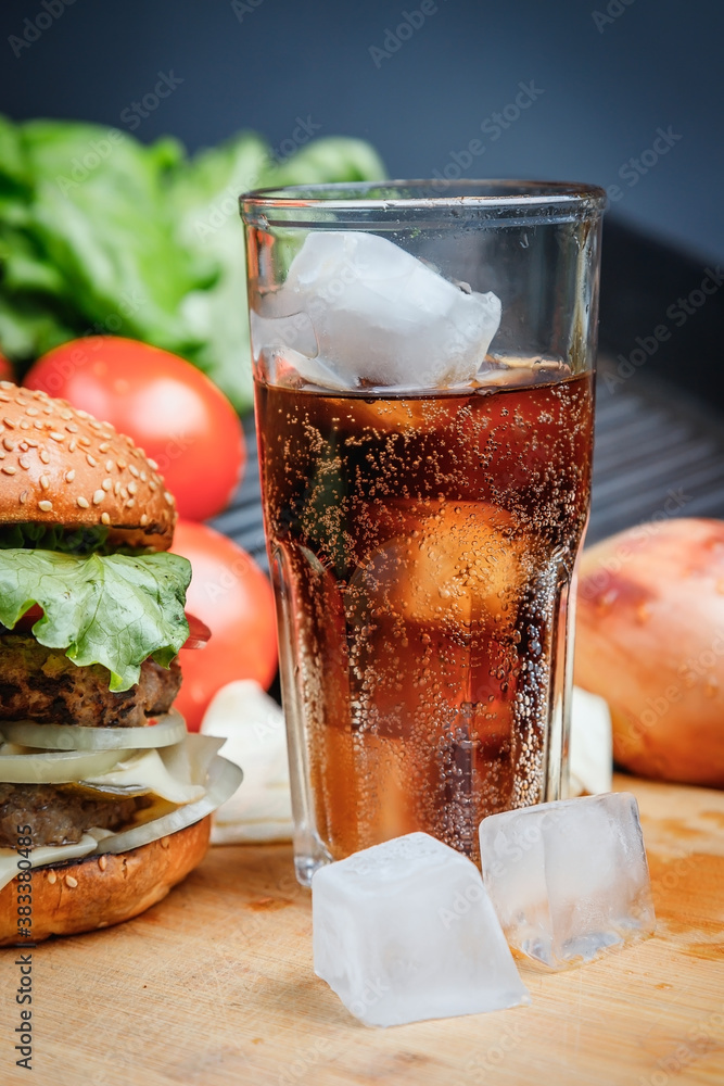 Delicious, juicy Burger and brown carbonated drink. Delicious, juicy Burger and brown carbonated drink.