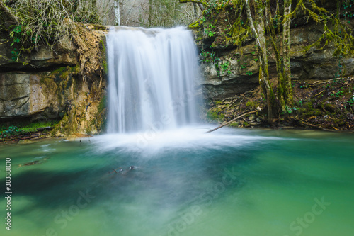 Beautiful little waterfall and colorful green pond.  Vallfogona de Ripolles  Torrent de la Masica  Catalonia  Spain 