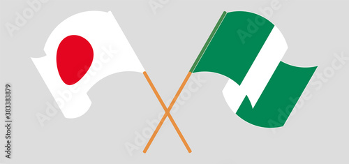 Crossed and waving flags of Nigeria and Japan