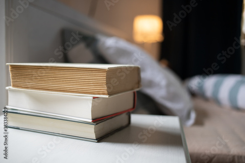 books on bedroom table by bed