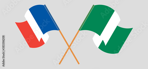 Crossed and waving flags of Nigeria and France