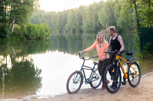 Couple in love on bikes in the woods in the park