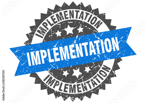 implementation stamp. grunge round sign with ribbon