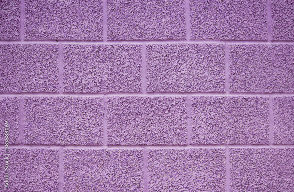 Fototapeta premium purple wall of the house on the street. the plaster has a texture and is covered with paint. beautiful background
